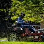 a person mowing the lawn grass