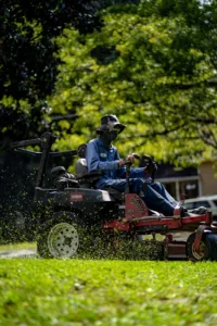 a person mowing the lawn grass