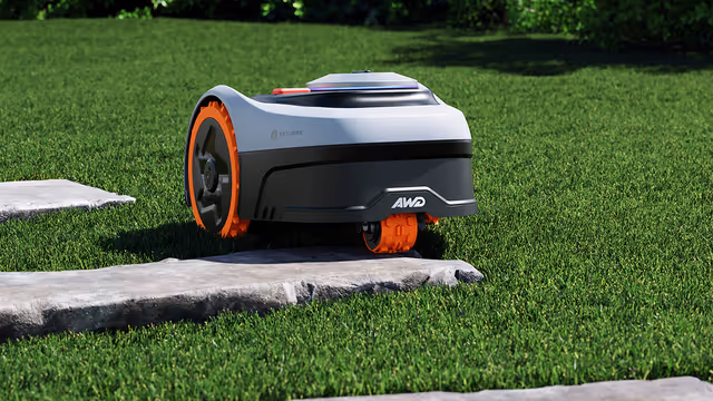 Navimow i2 AWD driving across rough terrain